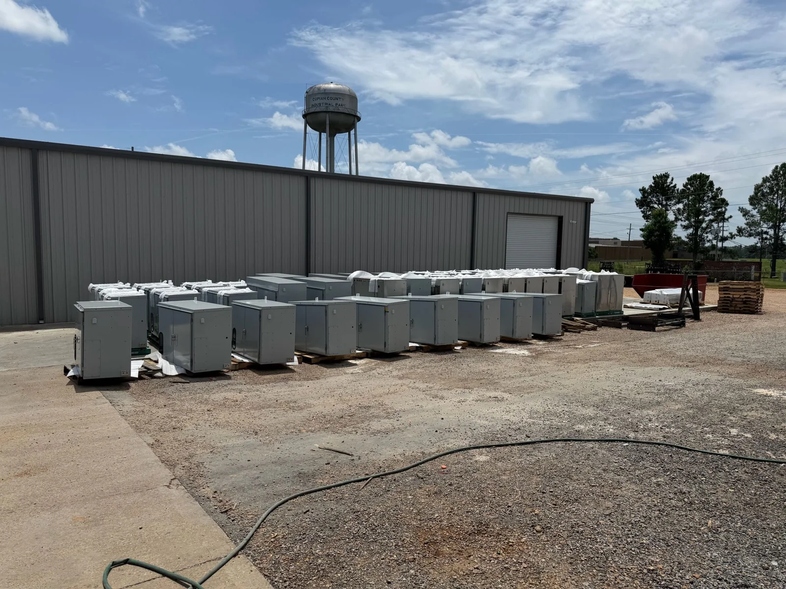 Powder-coated NEMA 3R transformer cabinets staged for shipment outside the FabTek Industries plant at Copiah County Industrial Park, Hazlehurst, Mississippi