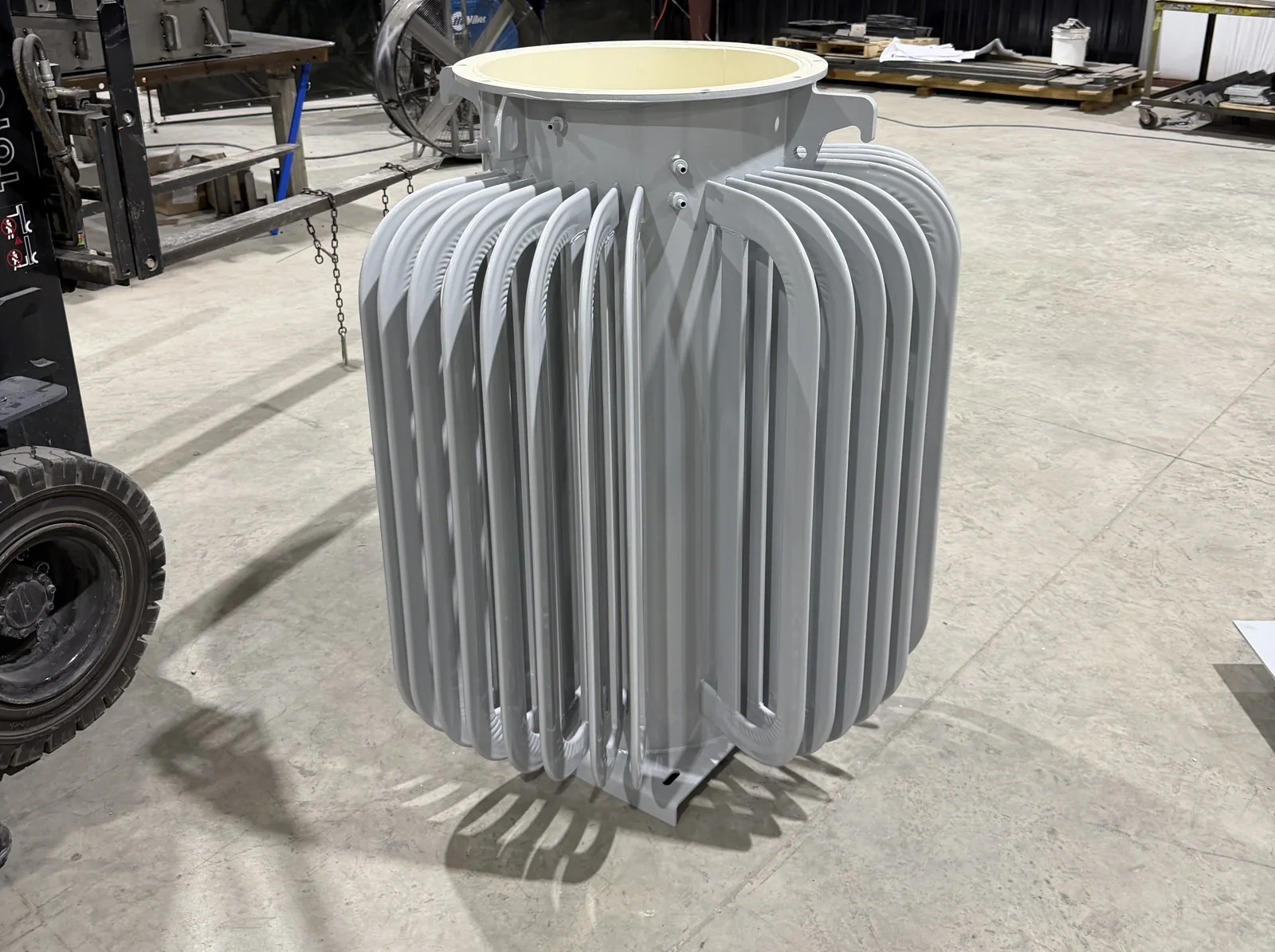 Finished tube-cooled transformer tank, painted and ready for an OEM, on the FabTek Industries fabrication floor in Hazlehurst, Mississippi