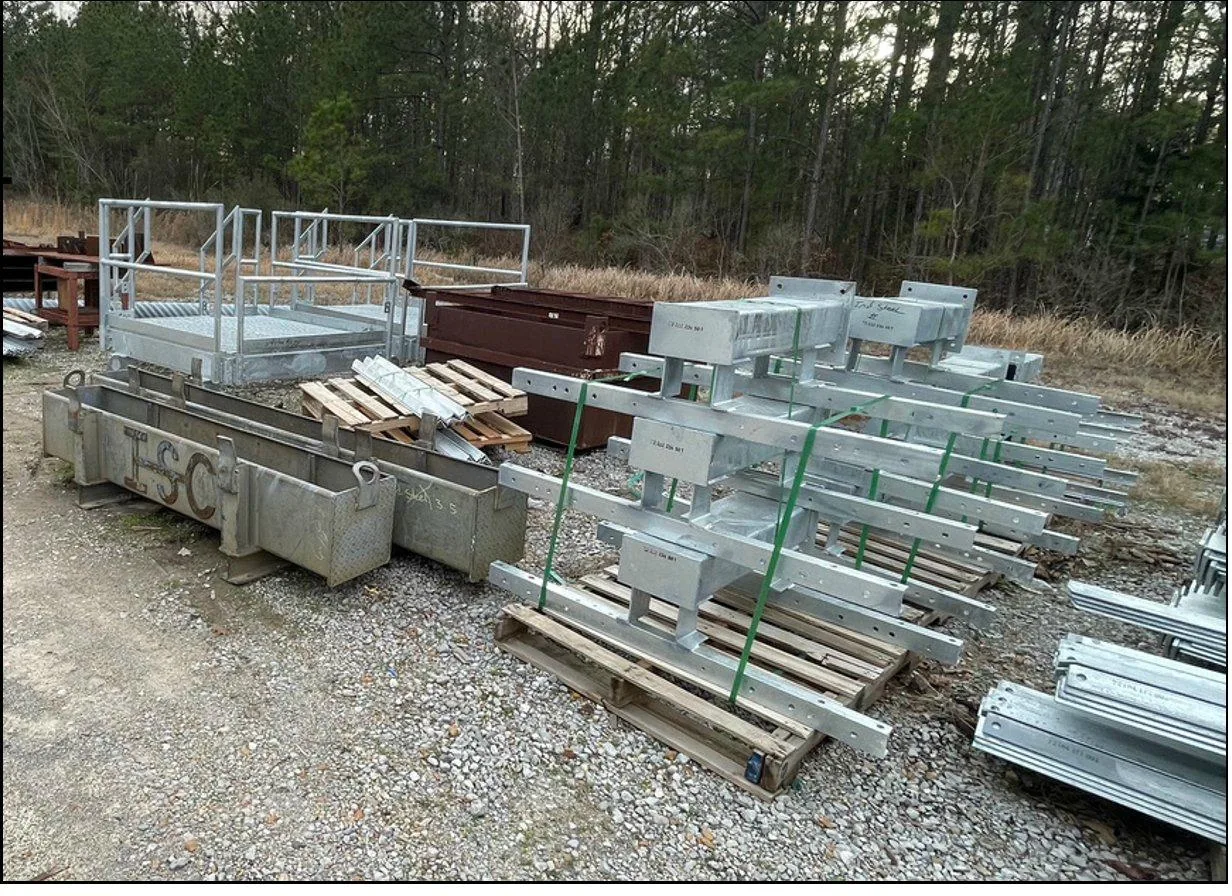 Freshly hot-dip galvanized substation structures and equipment stands staged on dunnage in the FabTek Industries yard in Hazlehurst, Mississippi
