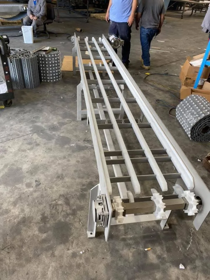 Frame with wear strips and sprockets — FabTek Industries